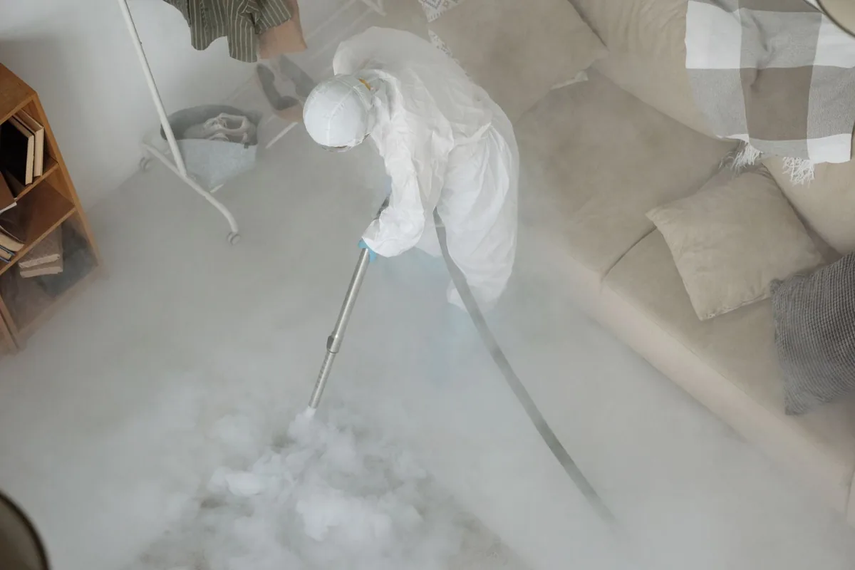 Biohazard cleanup technician in protective equipment, Coopersville, MI